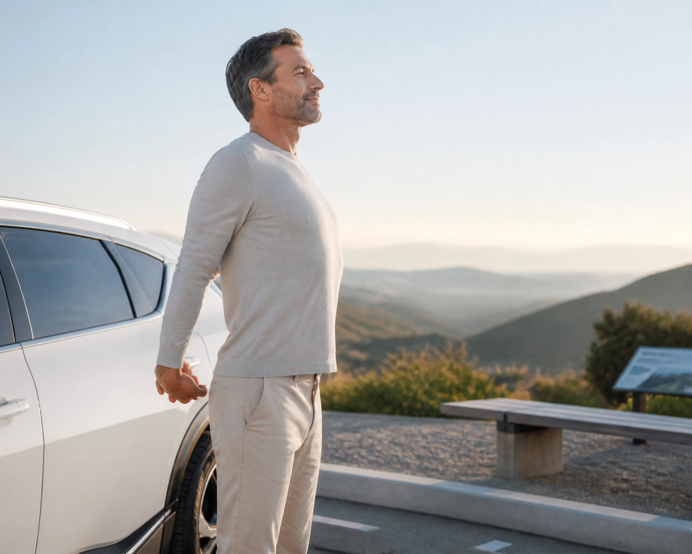 A driver doing a spinal reset movement next to their car to relieve sciatica pain during a road trip.
