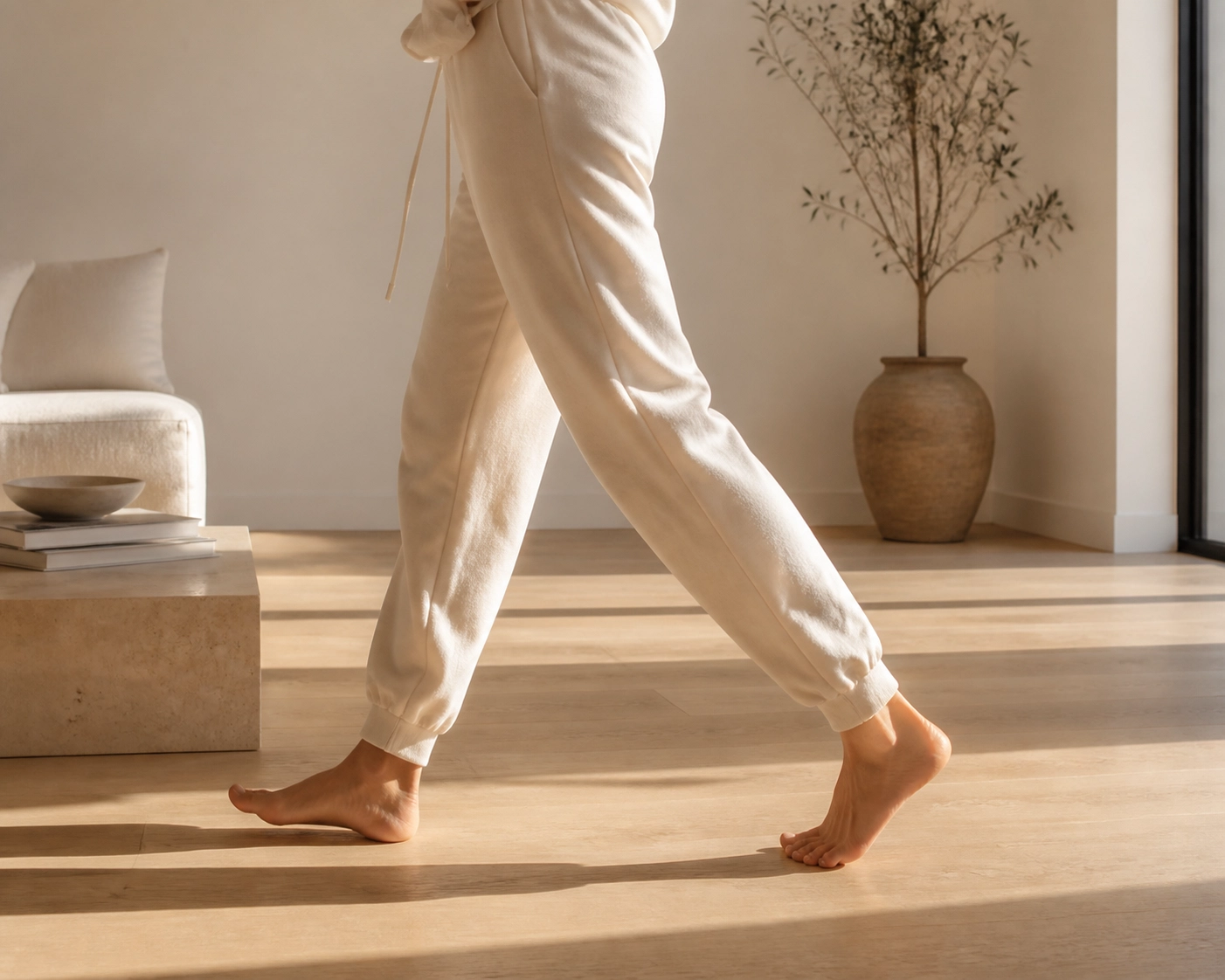 Person walking gently indoors to manage a sciatica flare-up and keep blood flowing.