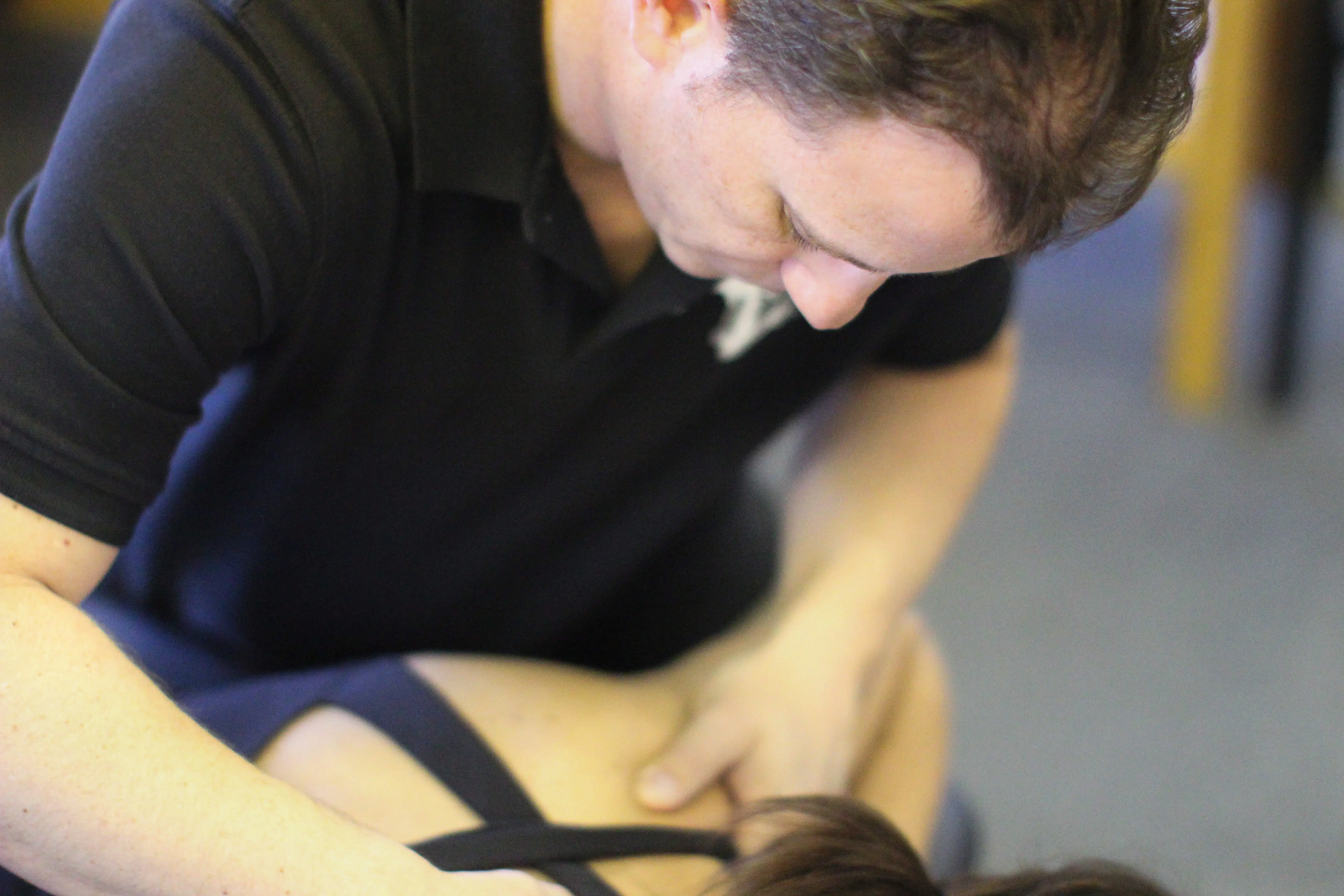 A specialist performing a hands-on assessment to balance the body and relieve pressure on the sciatic nerve